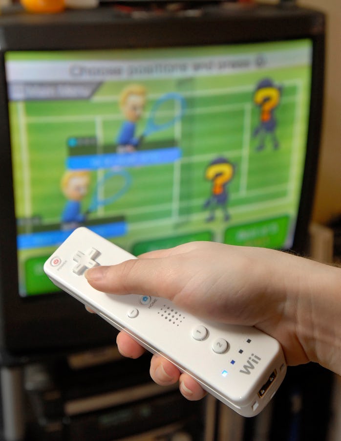 A photo of a hand holding a Wiimote.