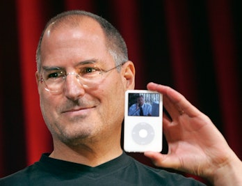 Steve Jobs holding an iPod.