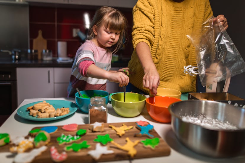 mom and kid baking holiday cookies 