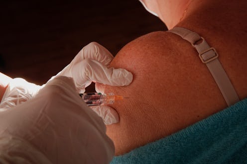 A person receives the covid-19 vaccine. The covid-19 vaccine's side effects are mostly mild to moder...
