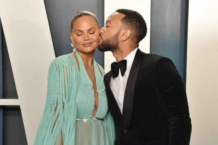 John Legend kissing Chrissy Teigen on the cheek at the 2020 Vanity Fair Oscars Party