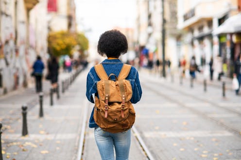 A woman walks a city street. Stress can hurt heart health in multiple ways, according to experts.