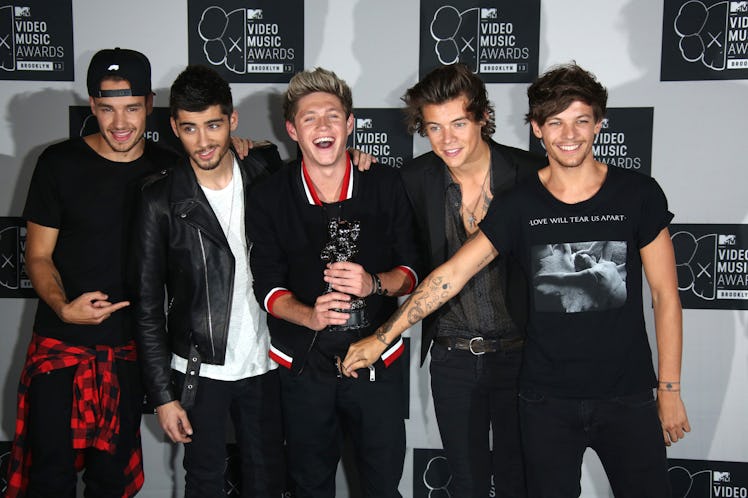 One Direction proudly hold up their VMA Award.