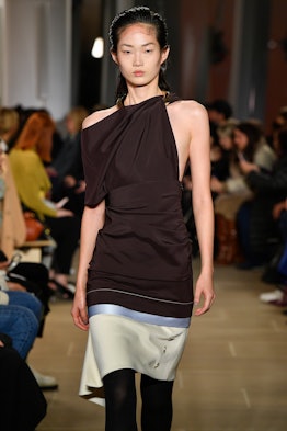 A model walking in a brown asymmetric halter-neck dress at Proenza Schouler's Fall/Winter 2020 Runwa...