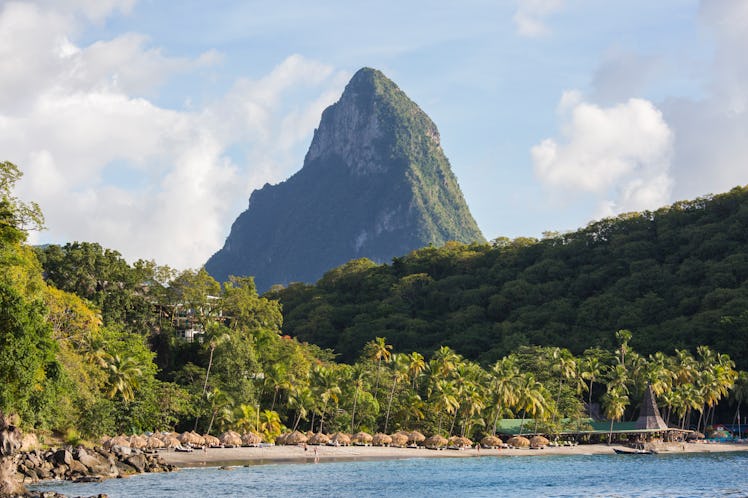 The lush mountains of Saint Lucia tower over the cozy beaches on a sunny afternoon.