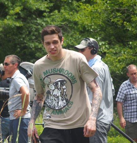 Pete Davidson walking in a hunt mushrooms not animals shirt