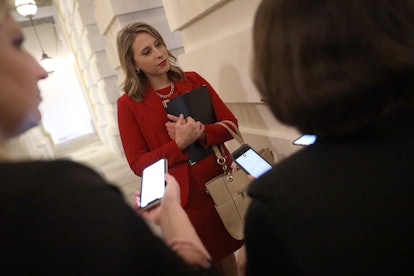 Katie Hill talking to two journalists holding their smartphones