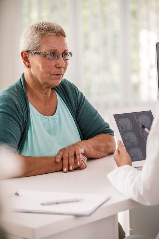 Woman listening to doctor explaining MRI test results - stock photo
