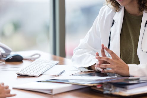 A doctor at their office. Being body-shamed at the doctor's is a common experience for people of a h...