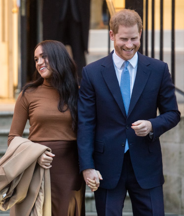 Meghan Markle and Prince Harry step out hand in hand.