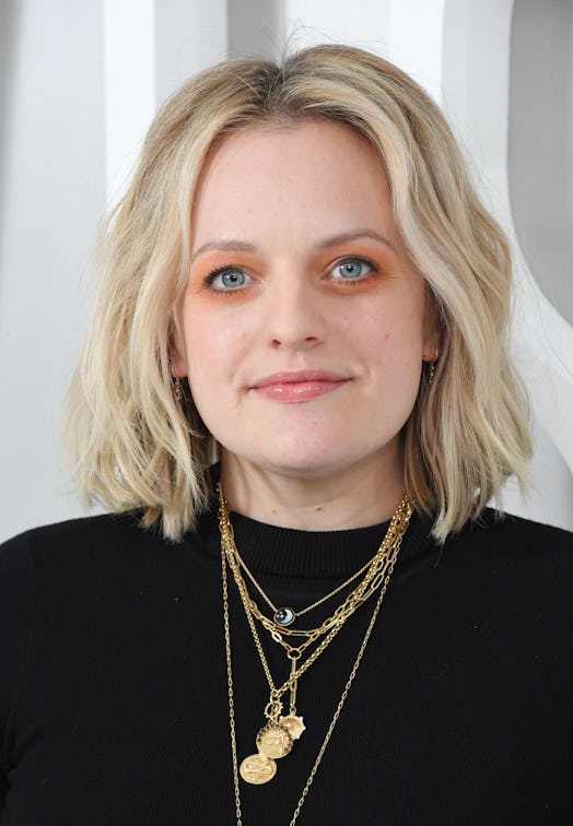 Elisabeth Moss' orange eyeshadow and coral lip.