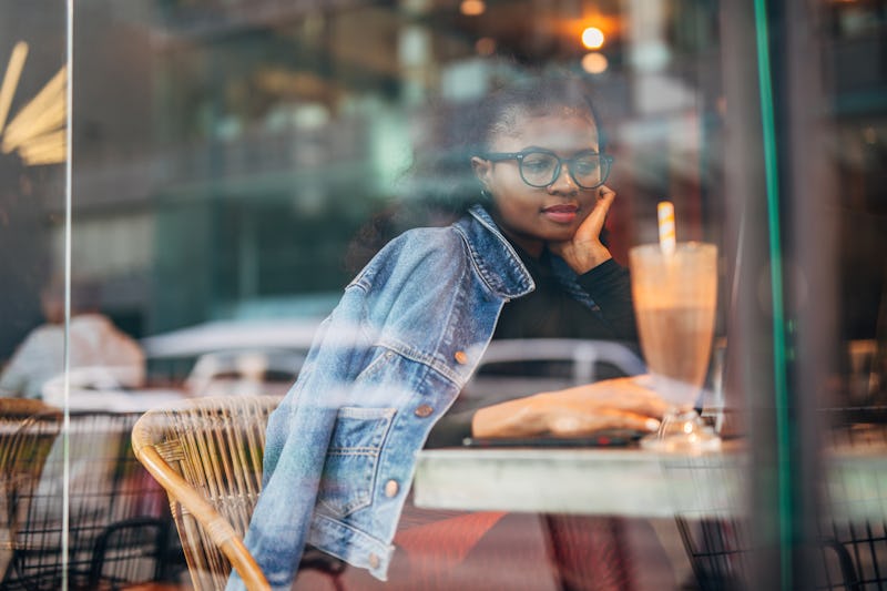 A woman sits inside a cafe. Experts reveal what happens to your body when you stop being vegetarian