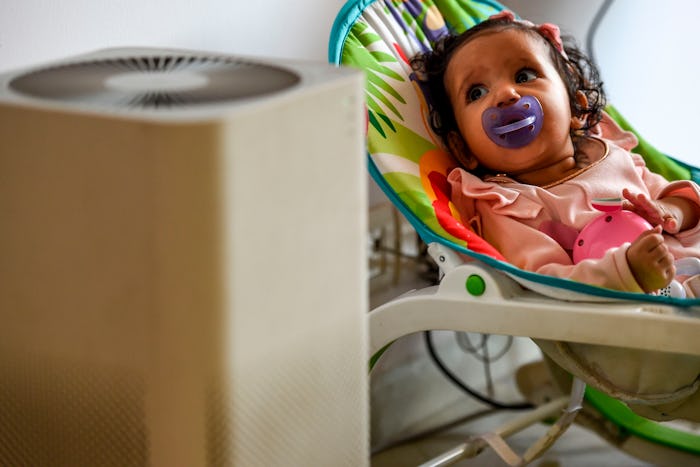 baby next to an air purifier