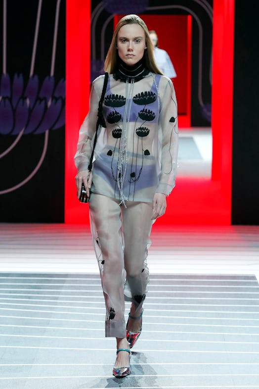 A model walking the Prada Fall 2020 runway in a sheer set with black circles on the blouse