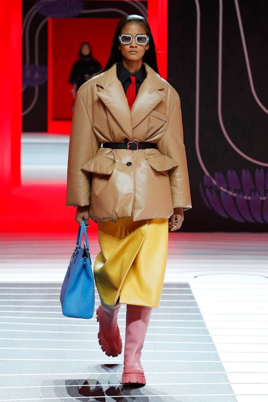A model walking the Prada Fall 2020 runway in a beige leather puffer coat