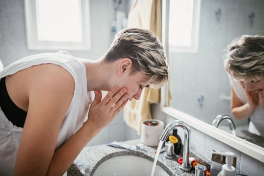 woman washing face as good hygiene