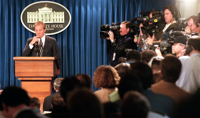 White House Press Secretary Mike McCurry, surrounded by the media, answers questions Jan. 22, 1998 d...