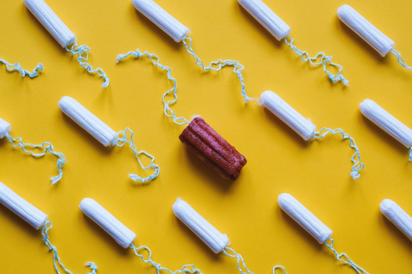 A row of tampons, with one used in the middle. A missing period, if you're not pregnant, is always c...