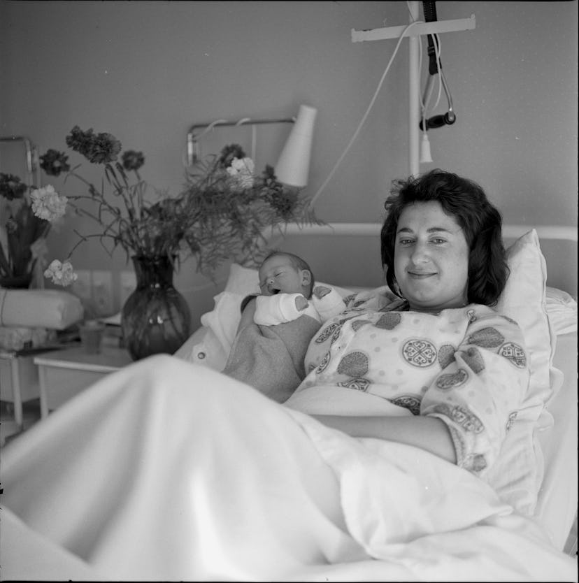 This 1960 hopsital photo of mom and baby is made even more cozy by the beautiful floral arrangements...