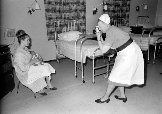 Midwife May Guthrie-Lacy snaps a photo of a mom and brand new baby in 1969.