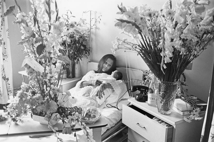 A French maternity ward is full of flowers for this mom and her new baby snuggling in the hospital b...