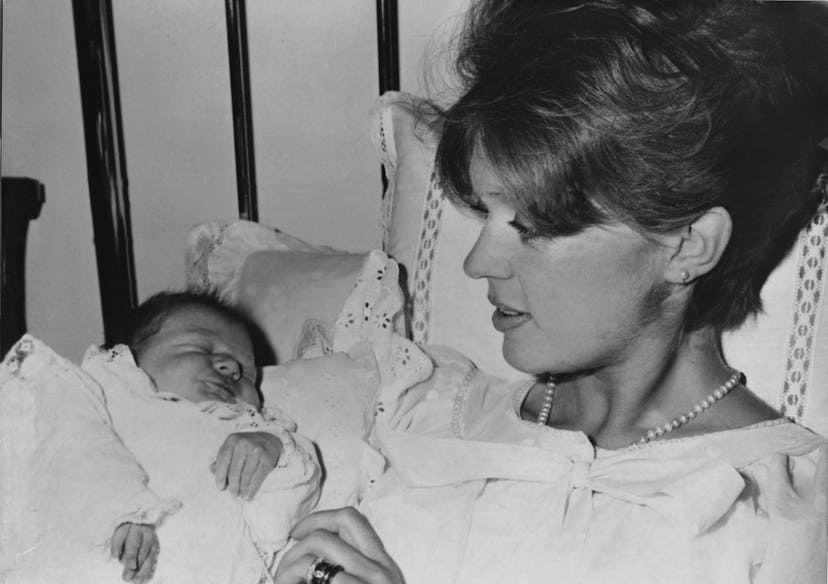 Princess Birgitta of Sweden looks down at her sweet baby in the 1960s inside this Munich hospital.