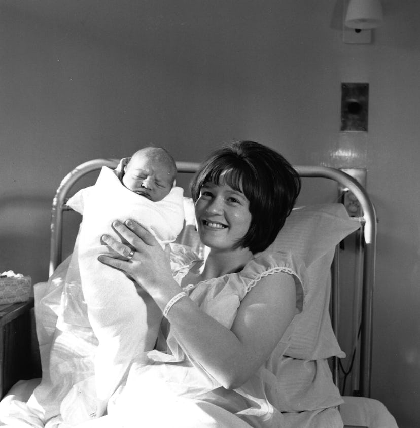 This 1965 mom holding up her baby for the camera proudly is just so sweet.