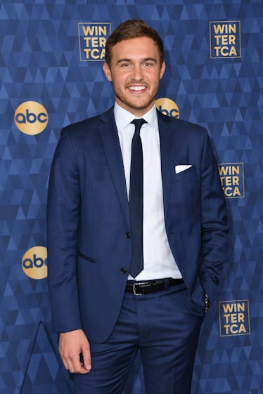 Peter Weber in a navy suit, a white shirt, and a black tie during a red carpet event