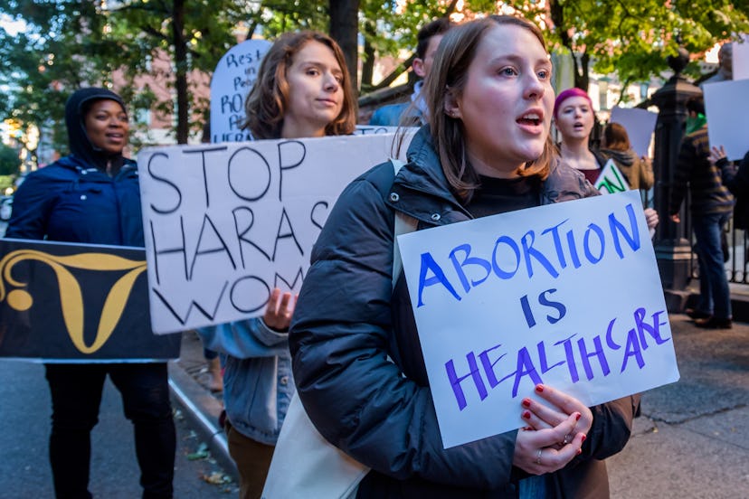 A person holds a sign saying "Abortion is Health Care." It will now be easier to access reproductive...