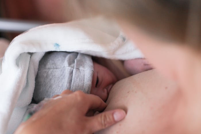 a newborn baby breastfeeding