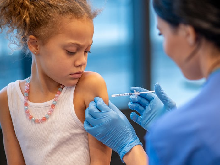 a little girl getting the flu shot