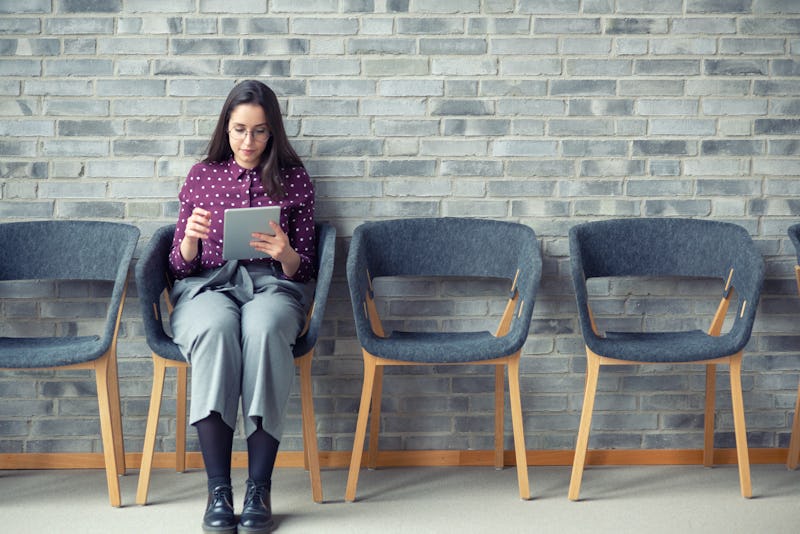 A woman sits in a therapy waiting room, brainstorming what to talk about for a more productive thera...