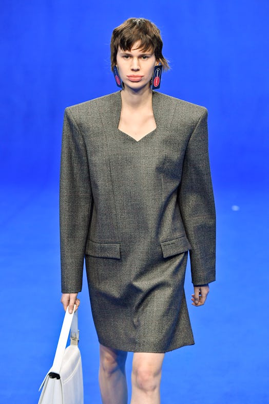  A model wearing a grey Balenciaga Spring/Summer 2020 power suit dress inspired by the '80s