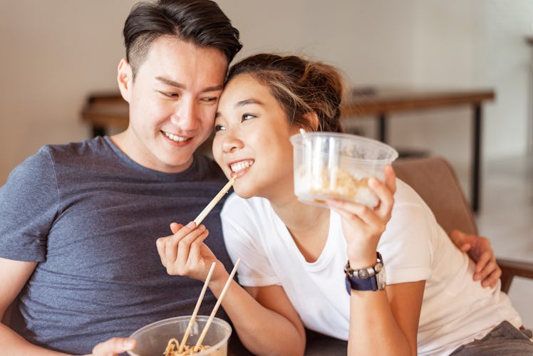 a couple ordering takeout and enjoying an affordable date night