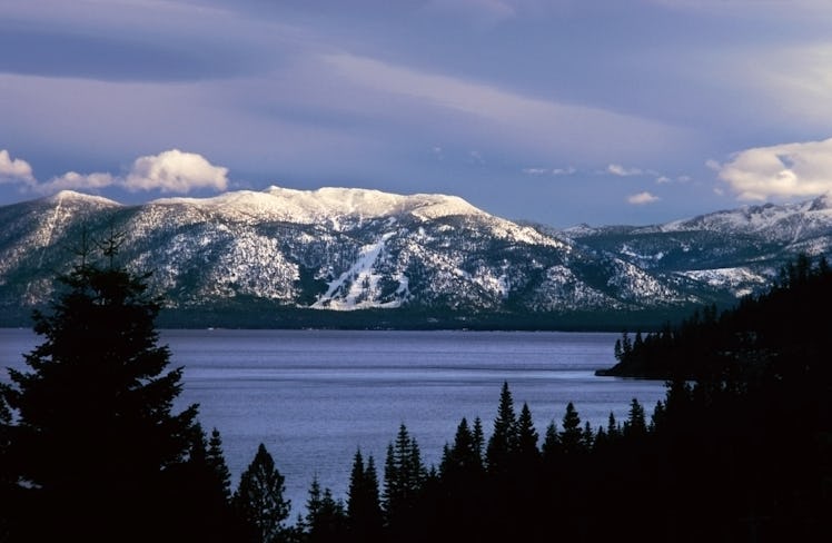 The mountains of Lake Tahoe, California are covered with snow in the winter.
