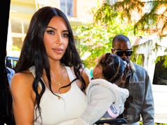 Kim Kardashian steps out with Chicago West and Kanye West.