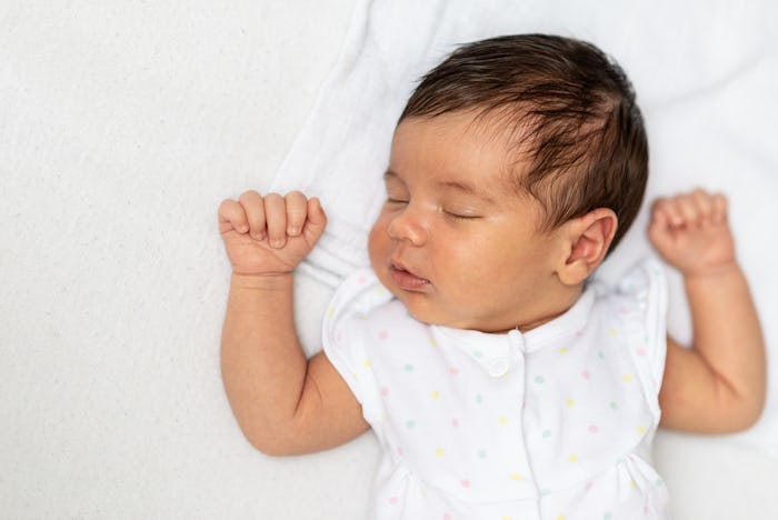 baby girl sleeping on her back