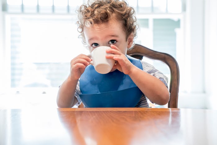 a toddler boy drinking tea