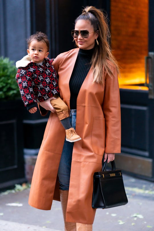 Chrissy Teigen did yoga with Miles crawling all over her.