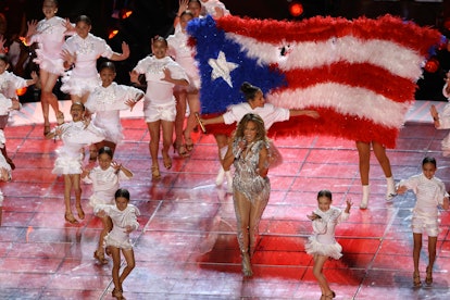 J. Lo performs on stage at the Super Bowl with her daughter. 