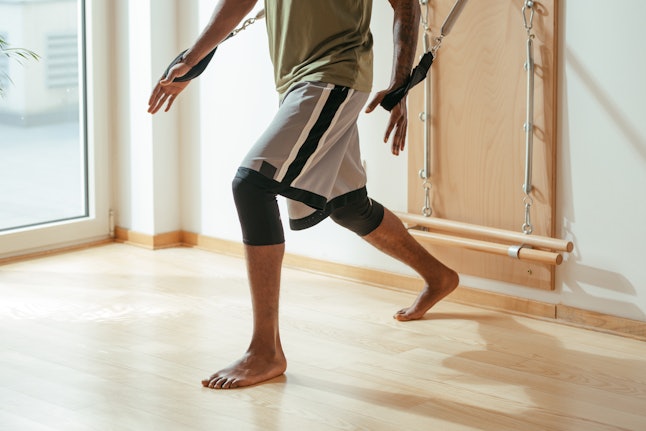 A man uses a Pilates springboard to get all the ways pilates can affect your brain and body.