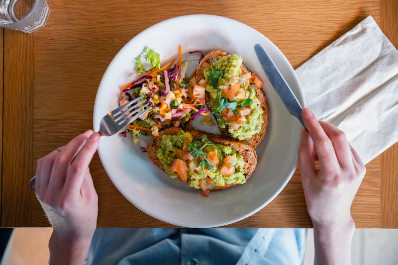 A diner tucks into vegetarian avocado toast. Going vegetarian isn't tricky, but it can be a big diet...