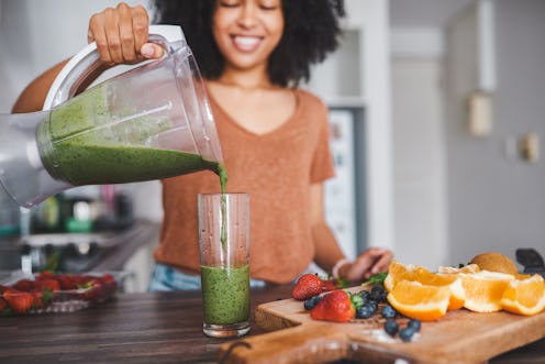 A woman makes a green juice as part of her nutritionist-backed plan to become vegetarian