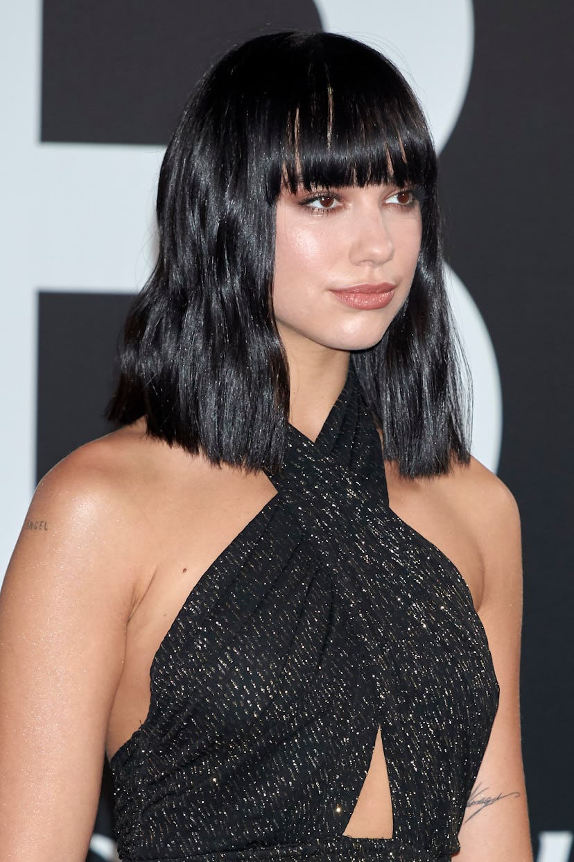 Dua Lipa's bangs are blunt and cut just below the eyebrows