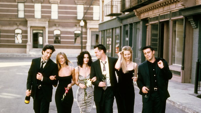 The cast of Friends walking all together hand in hand down the street