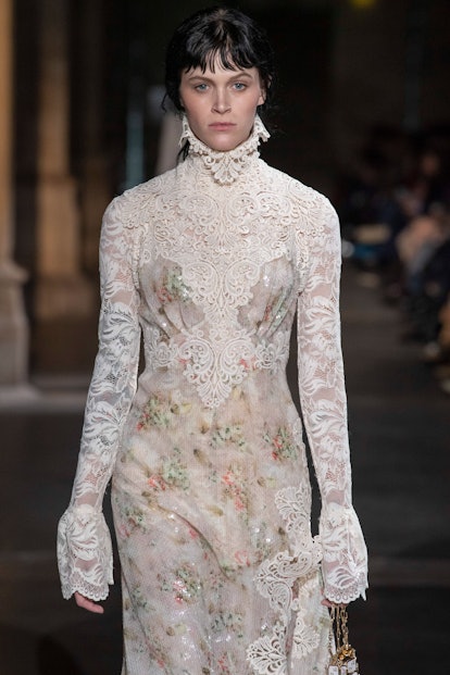 A female model walking in a white gown