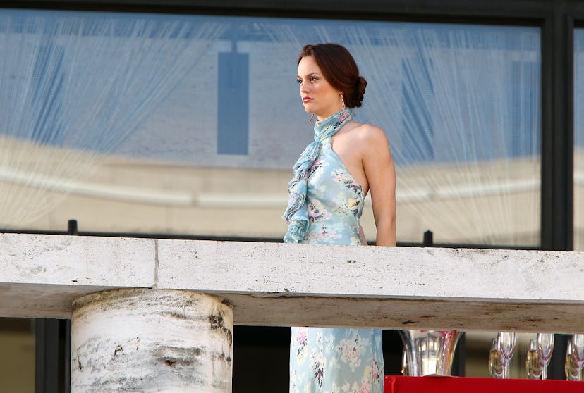 Leighton Meester in a light blue floral dress and chignon on a balcony