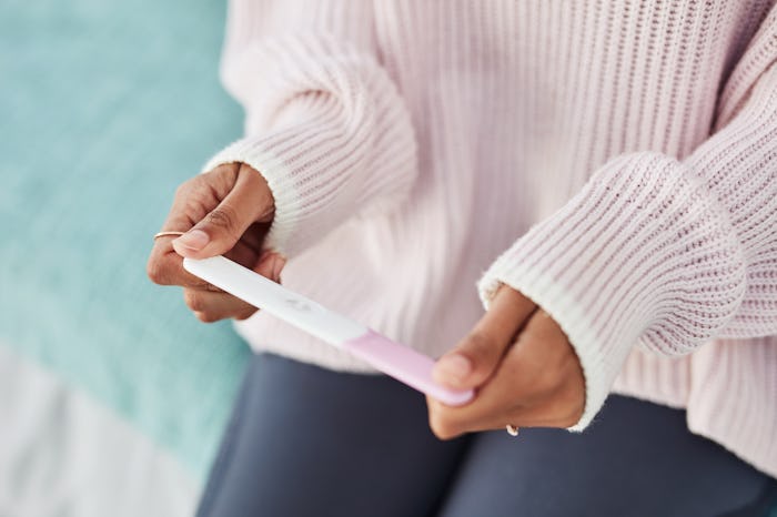 woman holding pregnancy test