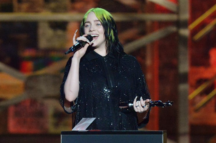 Billie Eilish accepts an award.