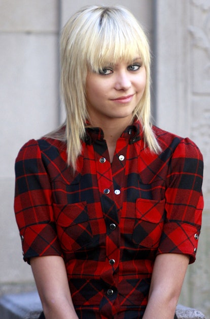 Taylor Momsen with a shag haircut in a red plaid shirt
